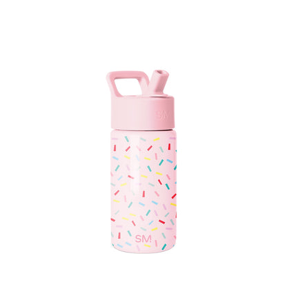 Simple Modern children's water bottle with soft pink body, colorful confetti pattern, screw-on cap with SM logo, pop-up straw spout, and carry handle on white background.