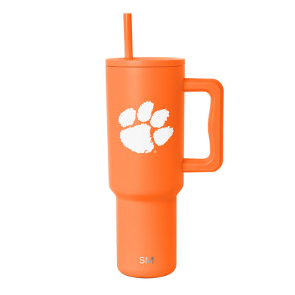 Vibrant bright orange tumbler with paw print design on white background